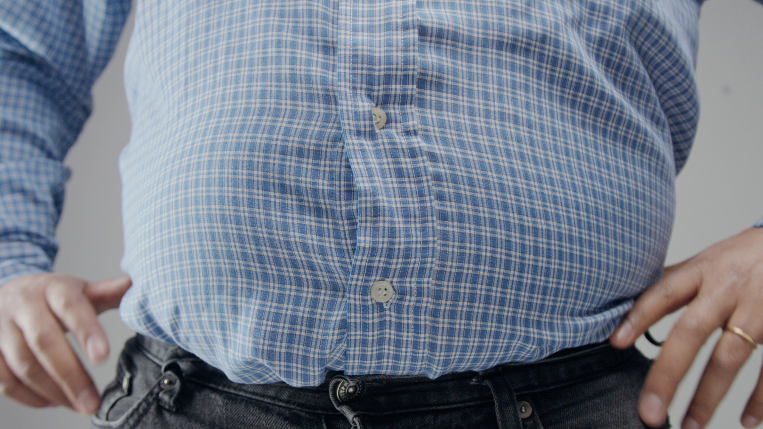 The Ultimate Guide to Losing Belly Fat Naturally In Just One Week 1 storyblocks overweight man in shrt is small to him with huge belly and open buttons HY kEsKdG scaled
